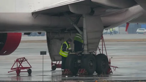 Aircraft maintenance mechanic inspects plane chassis, 4k uhd 2160p Stock Footage 63614732
