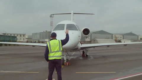 Aircraft Marshall Using Hand Sign For Private Jet Pilot Stock Footage 182550804
