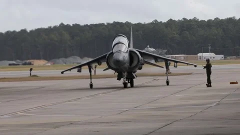 Aircraft marshaller singalling to AV-8B Harrier II pilot Stock Footage 263112093