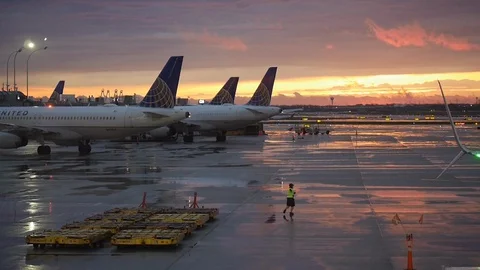 Aircraft marshaller at sunset Stock Footage 128404805