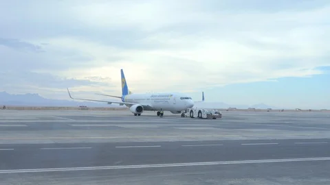 An Aircraft Pushback Tug Deploys an Airplane Stock Footage 128981990