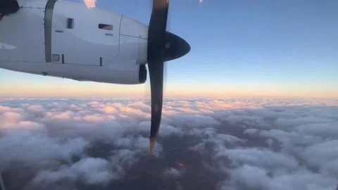 An aircraft is soaring through the cloudy sky during sunset Video stock 282343343