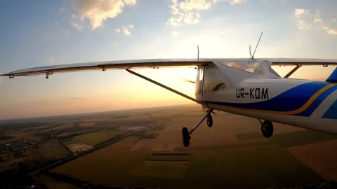 Aircraft soaring through the sky at sunset, showcasing the expansive landscape Stock Footage 315587816