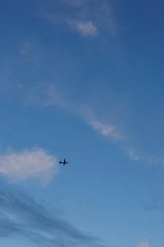 An aircraft soars through the evening sky Stock Photos