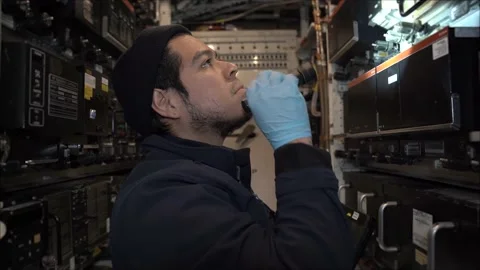 Aircraft Technician working in the electronics bay of a 757 commercial airplane. Stock Footage 237403543