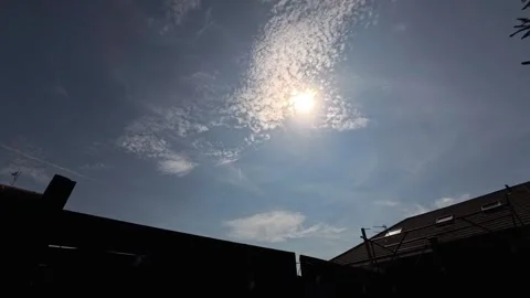Aircraft trails and light cloud time lapse crosses blue sky over residential Stock Footage 342801875