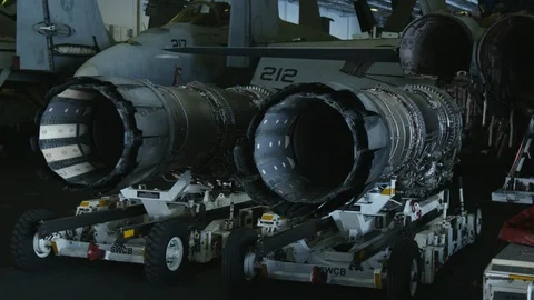 An aircraft turbofan engine sets on a stand inside the USS Carl Vinson Stock Footage 117717015