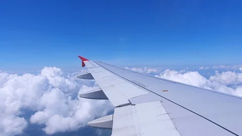 Aircraft window view clouds with blue sky background.Passenger with aviation. Video stock 118748410