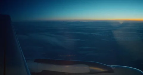 Aircraft Window View while Flying Above the Clouds at Sunset Stock Footage 343594397