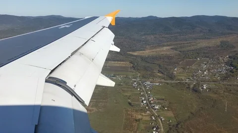 Aircraft wing on the background of the landscape Stock Footage 119358324