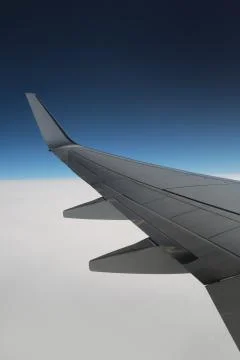 Aircraft wing on the clouds, Flying background vertical. Beautiful view Stock Photos