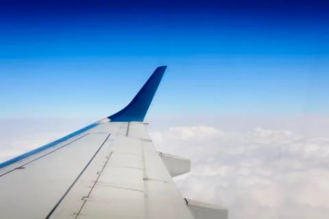 Aircraft wing over clouds Stock Photos