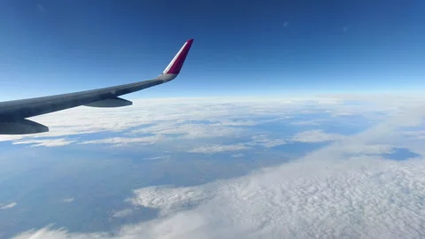 Aircraft Wing With Red Winglet Soaring Above White Cloud Layer in Blue Sky Video stock 310102613