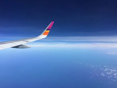 Aircraft Wing View of a plane while flying in the sky Stock Photos