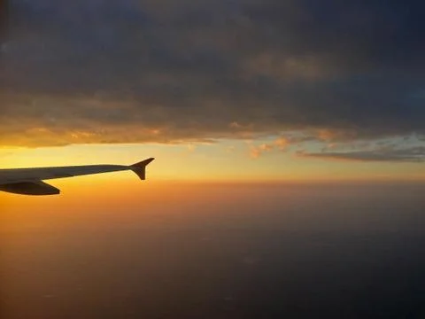 Aircraft Wing View of a plane while flying in the sky Stock Photos