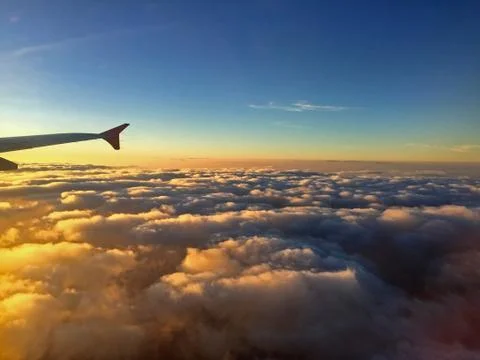 Aircraft Wing View of a plane while flying in the sky Stock Photos
