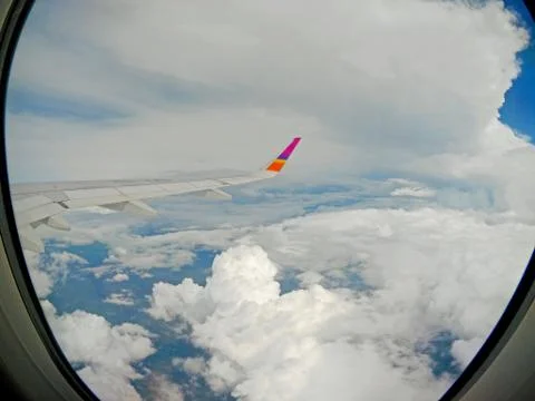 Aircraft Wing View of a plane while flying in the sky Stock Photos