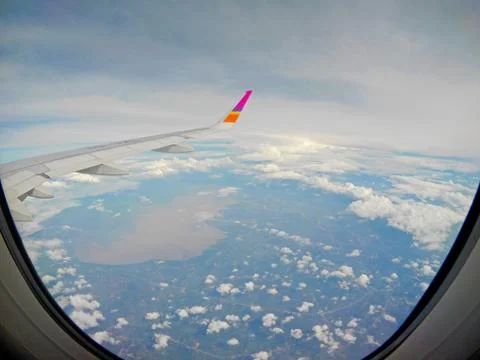 Aircraft Wing View of a plane while flying in the sky Stock Photos