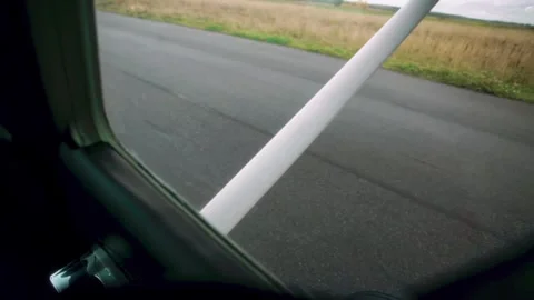 Aircraft wing visible from cabin window as it approaches runway, showcasing the Video stock 328481035