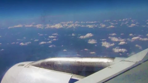 Aircraft wing in the window in flight among the clouds Stock Footage 121732962