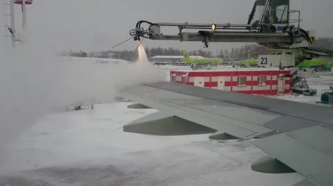 Aircraft Wings Defrosting With Antifreeze Before Takeoff During Strong Blizzard Stock Footage 59450189