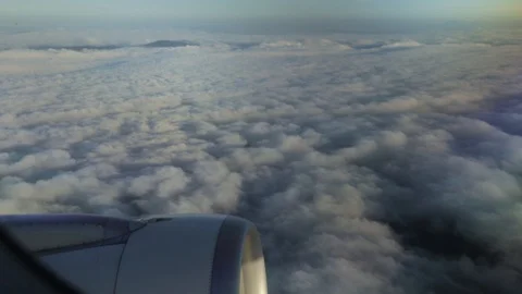 Aircraft's window above dense clouds on cloudyday Video stock 127874645