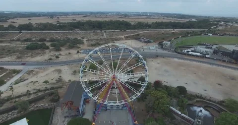 Airial tracking back exposing Ferris Wheel Video stock 82469249