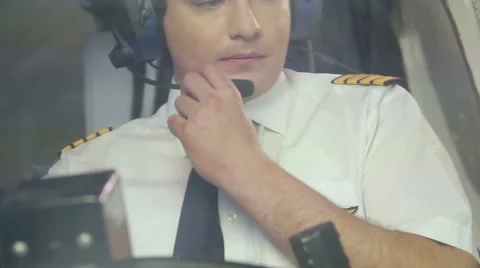 Airline captain flying plane, transmitting information over radio to dispatcher Stock Footage 64601069