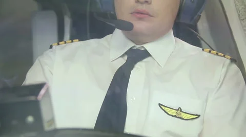 Airline captain flying plane, transmitting information over radio to dispatcher Stock Footage 64602799