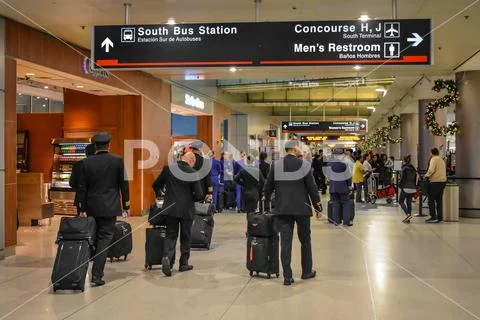 Airline crew walking in Terminal H at Miami International Airport Stock Photos