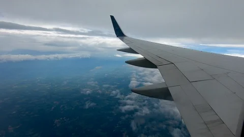 AIRLINE FLIGHT WINDOW CLOUDS SUNBEAMS RAIN STORM CLOUDS Stock Footage 92648459
