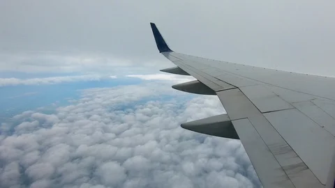 AIRLINE FLIGHT WINDOW CLOUDS SUNBEAMS RAIN STORM CLOUDS Stock Footage 92648811