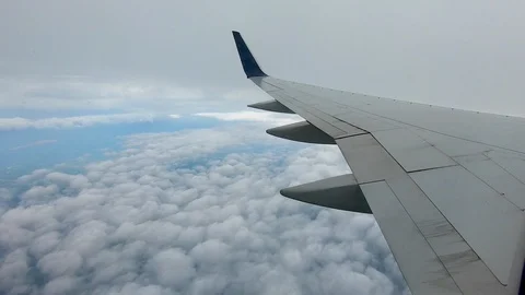 AIRLINE FLIGHT WINDOW CLOUDS SUNBEAMS RAIN STORM CLOUDS Stock Footage 92648812