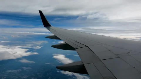 AIRLINE FLIGHT WINDOW CLOUDS SUNBEAMS RAIN STORM CLOUDS Stock Footage 92655484