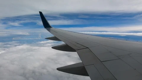 AIRLINE FLIGHT WINDOW CLOUDS SUNBEAMS RAIN STORM CLOUDS Stock Footage 92655490