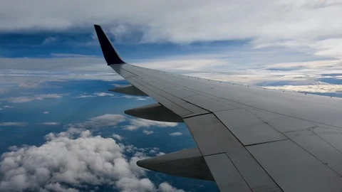 AIRLINE FLIGHT WINDOW CLOUDS SUNBEAMS RAIN STORM CLOUDS Stock Footage 92655863
