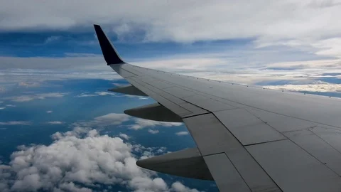 AIRLINE FLIGHT WINDOW CLOUDS SUNBEAMS RAIN STORM CLOUDS Stock Footage 92674513