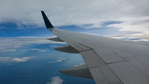 AIRLINE FLIGHT WINDOW CLOUDS SUNBEAMS RAIN STORM CLOUDS Video stock 92674607