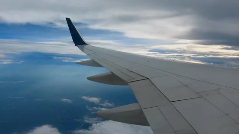 AIRLINE FLIGHT WINDOW CLOUDS SUNBEAMS RAIN STORM CLOUDS Stock Footage 92674747