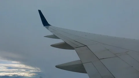 AIRLINE FLIGHT WINDOW CLOUDS SUNBEAMS RAIN STORM CLOUDS Stock Footage 92674890