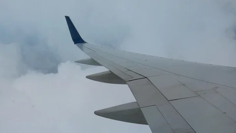 AIRLINE FLIGHT WINDOW CLOUDS SUNBEAMS RAIN STORM CLOUDS Stock Footage 92675052