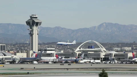 Airline Landing At Los Angeles International Airport With Mountains Stock Footage 1099678