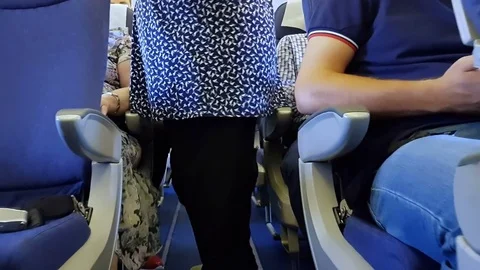 Airline passengers boarding a crowded plane gimbal shot Stock Footage 80582509