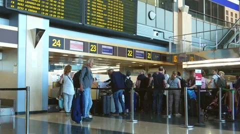 Airline passengers checking in at an airline counter in an Airport 動画素材 63311241