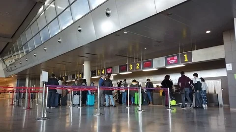 Airline Passengers checking in at an Airline Counter Stock-Footage 100712186