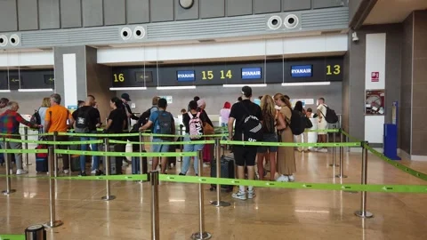 Airline Passengers Checking In at the Ryanair Desk Stock Footage 249385291