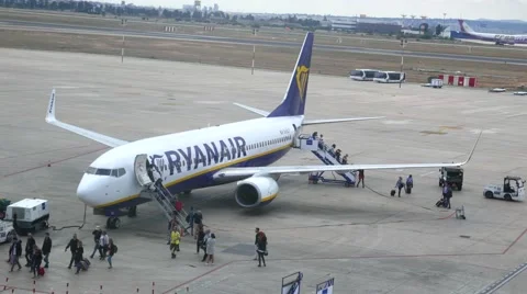 Airline passengers offloading a Ryanair aircraft Stock Footage