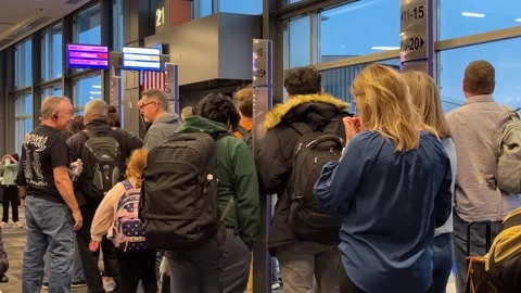 Airline passengers wait at the terminal gate to board airline flights Stock Footage 256249628