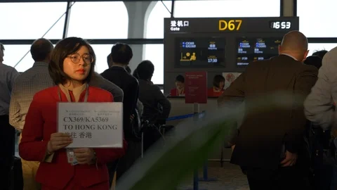 Airline Personnel Representative Holds Sign by Gate at Shanghai Pudong Airport Stock Footage