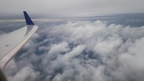 Airline window seat view above the clouds Stock Footage 295785839